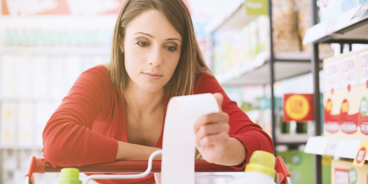 Shopper looking at grocery reciept